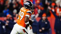 Denver Broncos cornerback Ja'quan McMillian (29) celebrates after intercepting a pass intended for Buffalo Bills wide receiver Brandin Cooks (not pictured) during overtime of an AFC Divisional Round playoff game at Empower Field at Mile High.
