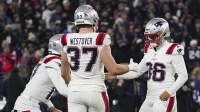 New England Patriots place kicker Andy Borregales (36) celebrates making a field goal against the Baltimore Ravens with punter Bryce Baringer (17) and tight end Jack Westover (37) during the first half of the game at M&T Bank Stadium.