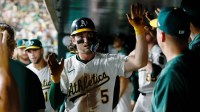 Athletics shortstop Jacob Wilson (5) celebrates in the dugout after scoring a run during the fourth inning against the Houston Astros at Sutter Health Park.
