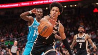 Atlanta Hawks forward Jalen Johnson (1) reaches for a loose ball against the Charlotte Hornets in the fourth quarter at State Farm Arena.