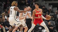 Atlanta Hawks forward Jalen Johnson (1) handles the ball against Brooklyn Nets forward Noah Clowney (21) and guard Egor Demin (8) during the first half at State Farm Arena.