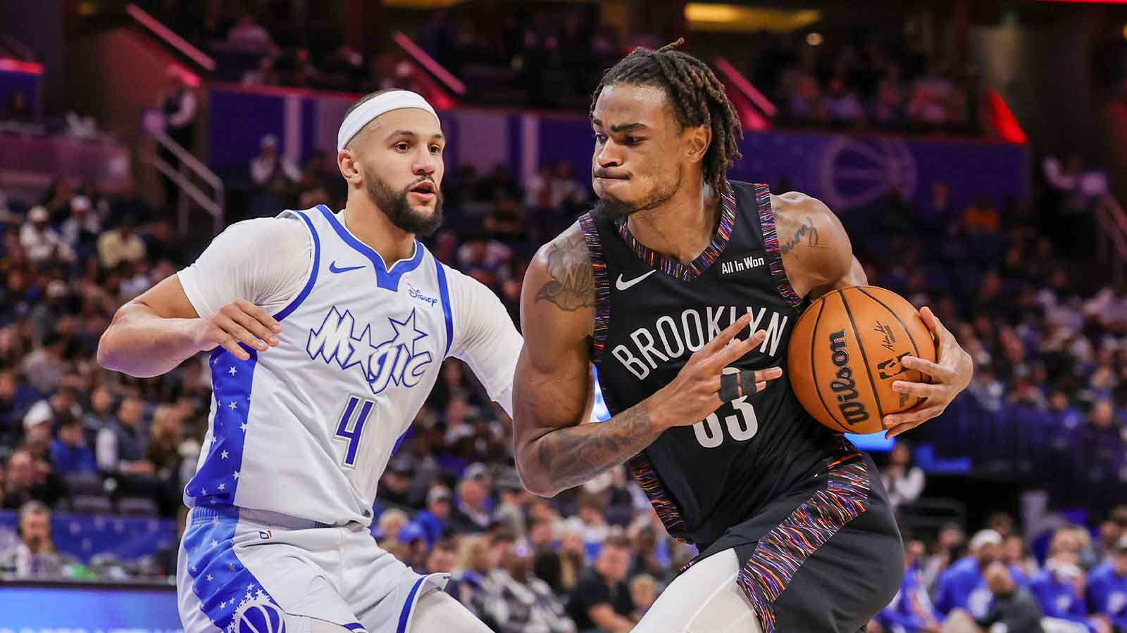 Brooklyn Nets center Nic Claxton (33) drives against Orlando Magic guard Jalen Suggs (4) during the second quarter at Kia Center.