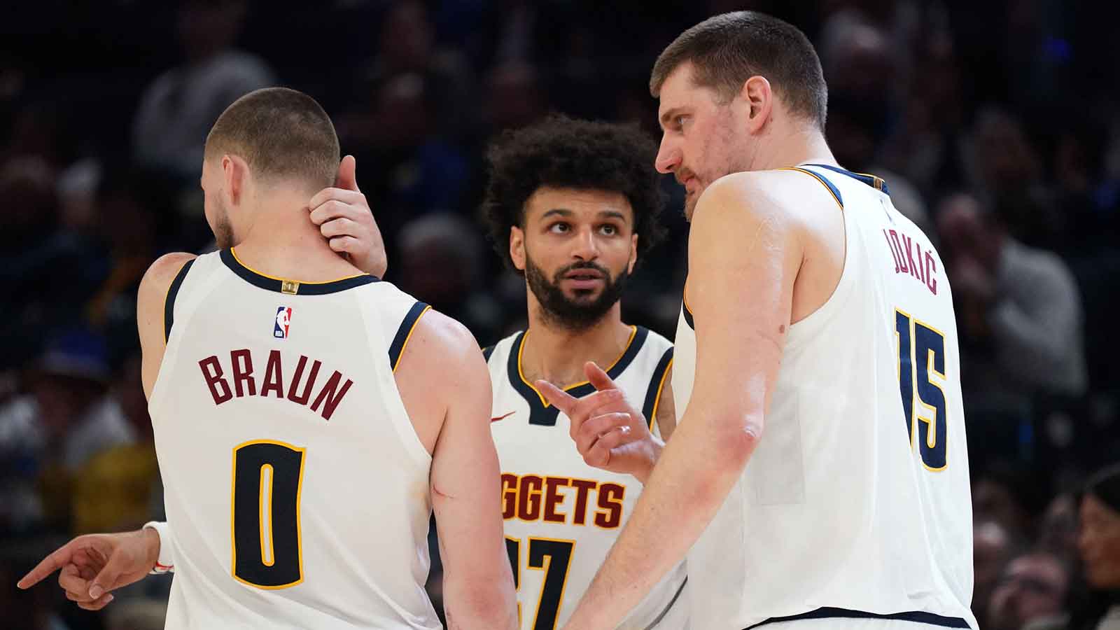 Denver Nuggets guard Jamal Murray (27) talks with guard Christian Braun (0) and center Nikola Jokic (15) in the fourth quarter against the Golden State Warriors at Chase Center.