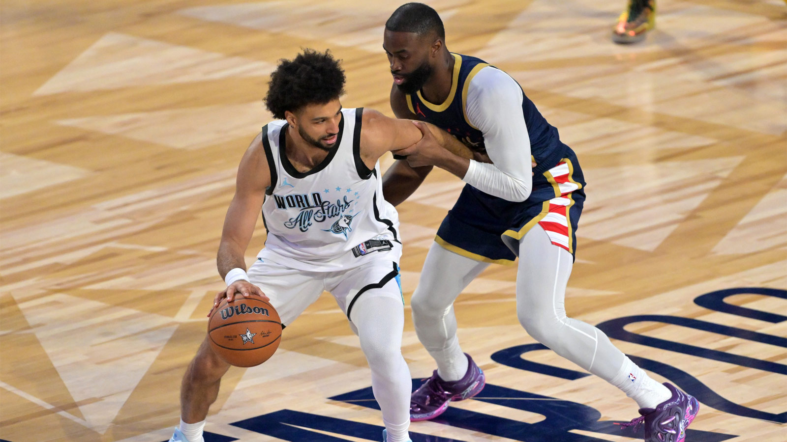 Team World guard Jamal Murray (27) of the Denver Nuggets controls the ball against Team USA Stripes forward Jaylen Brown (7) of the Boston Celtics in game three during the 75th NBA All Star Game at Intuit Dome. 