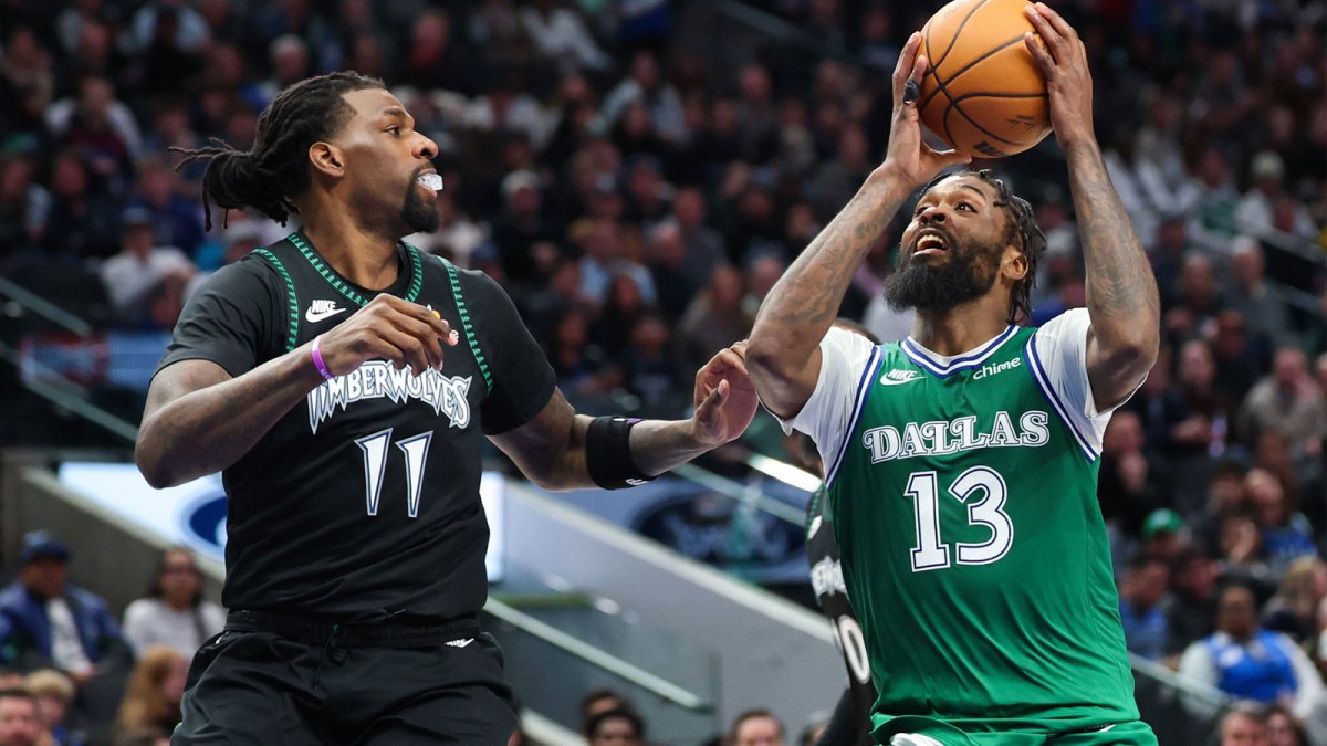 Jan 28, 2026; Dallas, Texas, USA; Dallas Mavericks forward Naji Marshall (13) shoots as Minnesota Timberwolves center Naz Reid (11) defends during the second half at American Airlines Center. Mandatory Credit: Kevin Jairaj-Imagn Images