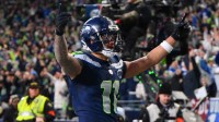 Seattle Seahawks wide receiver Jaxon Smith-Njigba (11) celebrates after scoring a touchdown against the Los Angeles Rams during the first half in the 2026 NFC Championship Game at Lumen Field.