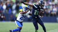 Seattle Seahawks wide receiver Jaxon Smith-Njigba (11) runs against Los Angeles Rams cornerback Roger McCreary (25) during the first half in the 2026 NFC Championship Game at Lumen Field.