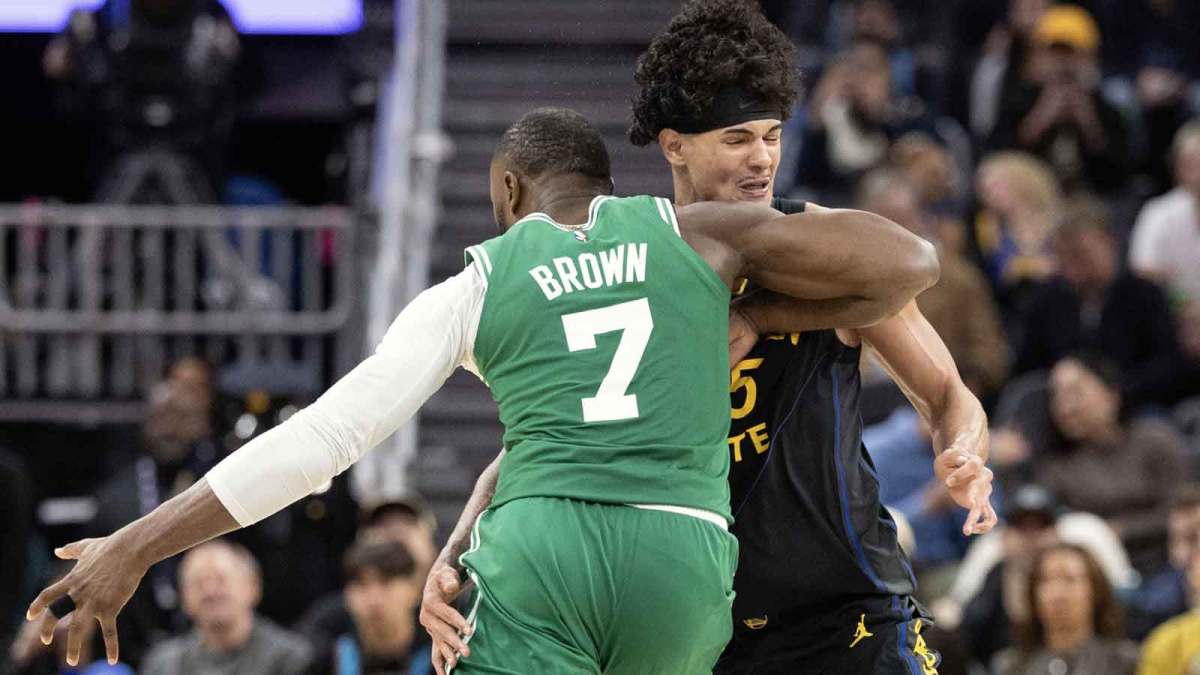 Golden State Warriors forward Gui Santos (15) commits a blocking foul against Boston Celtics guard Jaylen Brown (7) during the fourth quarter at Chase Center.