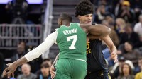 Golden State Warriors forward Gui Santos (15) commits a blocking foul against Boston Celtics guard Jaylen Brown (7) during the fourth quarter at Chase Center.