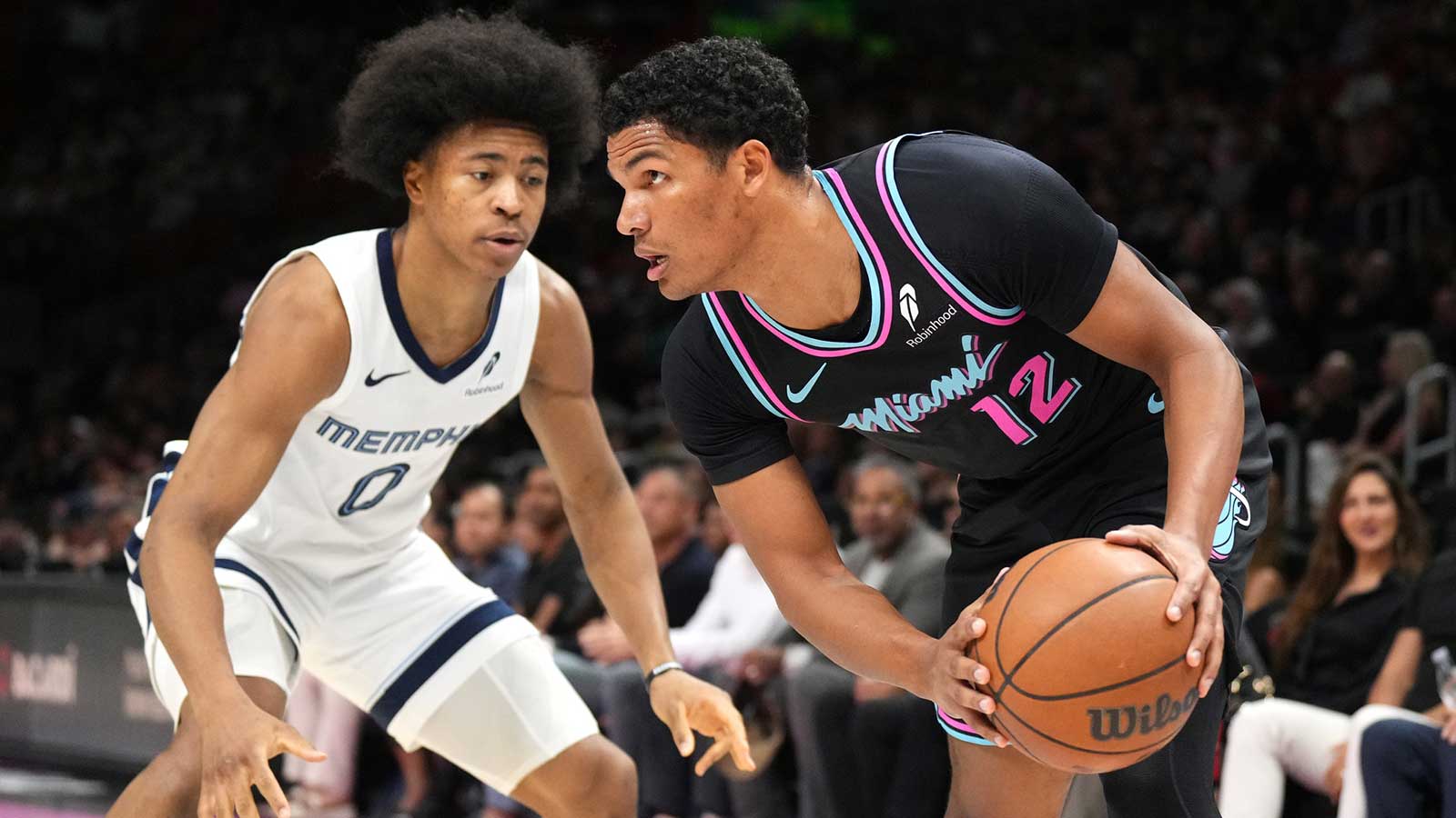 Miami Heat guard Dru Smith (12) looks to pass th ball as Memphis Grizzlies forward Jaylen Wells (0) defends during the first half at Kaseya Center.