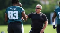 Philadelphia Eagles offensive line coach Jeff Stoutland runs a warmup during training camp at NovaCare Complex.