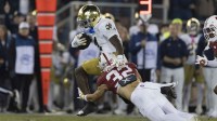 Notre Dame Fighting Irish running back Jeremiyah Love (4) attempts to run past Stanford Cardinal safety Mitch Leigber (32) during the first quarter at Stanford Stadium.