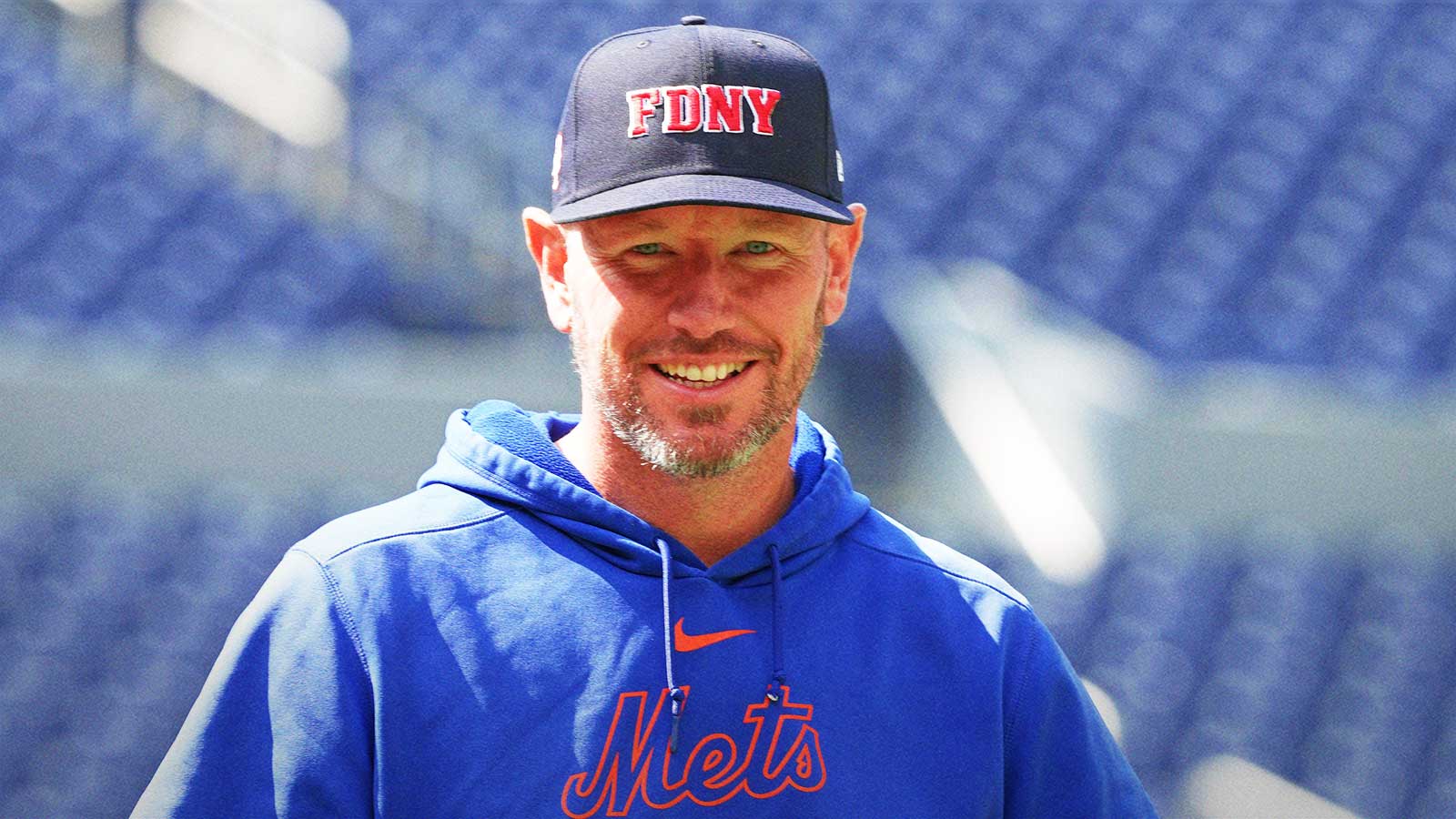 New York Mets pitching coach Jeremy Hefner (65) walks towards the outfield wearing a City of New York Fire Department baseball cap during batting practice before a game against the Toronto Blue Jays at Rogers Centre. 