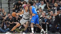 San Antonio Spurs forward Jeremy Sochan (10) drives in against Dallas Mavericks guard AJ Johnson in the second half at Frost Bank Center.