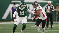 Atlanta Falcons running back Bijan Robinson (7) rushes the ball past New York Jets linebacker Jermaine Johnson (11) during the first half at MetLife Stadium.