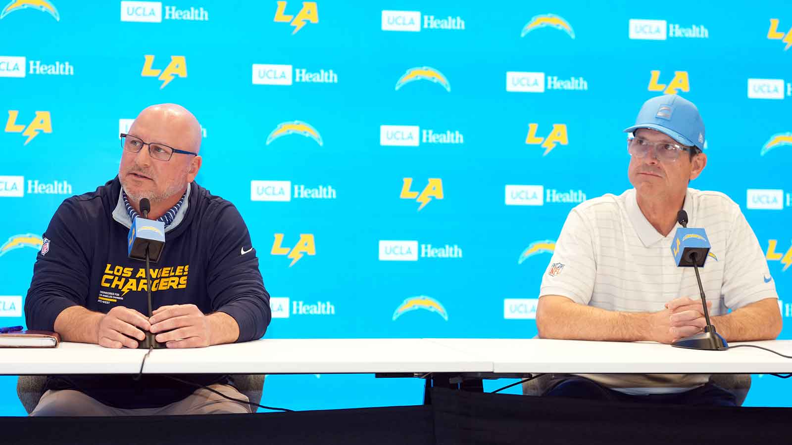 Los Angeles Chargers general manager Joe Hortiz (left) and coach Jim Harbaugh at press conference at The Bolt.