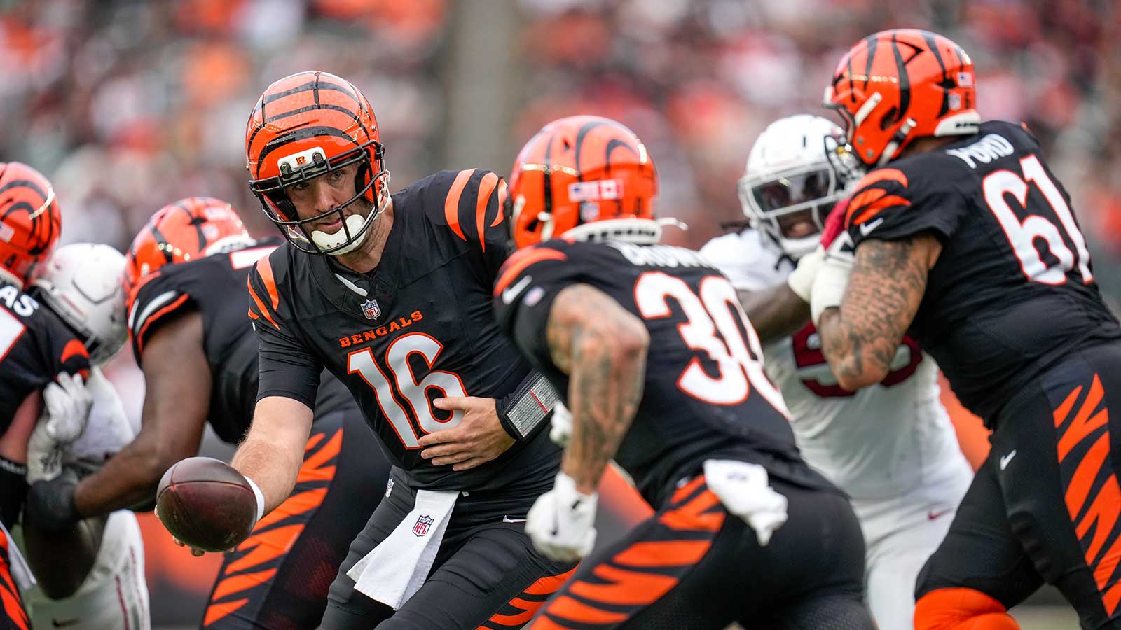 Cincinnati Bengals quarterback Joe Flacco (16) hands off to running back Chase Brown (30) in the fourth quarter at Paycor Stadium.