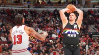 Denver Nuggets center Nikola Jokic (15) makes a three point basket over Chicago Bulls center Nick Richards (13) during the first half at United Center.