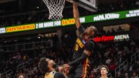 Atlanta Hawks forward Jonathan Kuminga (0) scores over Washington Wizards forward Justin Champagnie (9) during the second half at State Farm Arena.