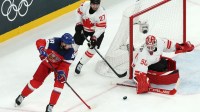 Tomas Hertl of Czech Republic in action with Jordan Binnington and Shea Theodore of Canada in a men's ice hockey Group A match during the Milano Cortina 2026 Olympic Winter Games at Milano Santagiulia Ice Hockey Arena.
