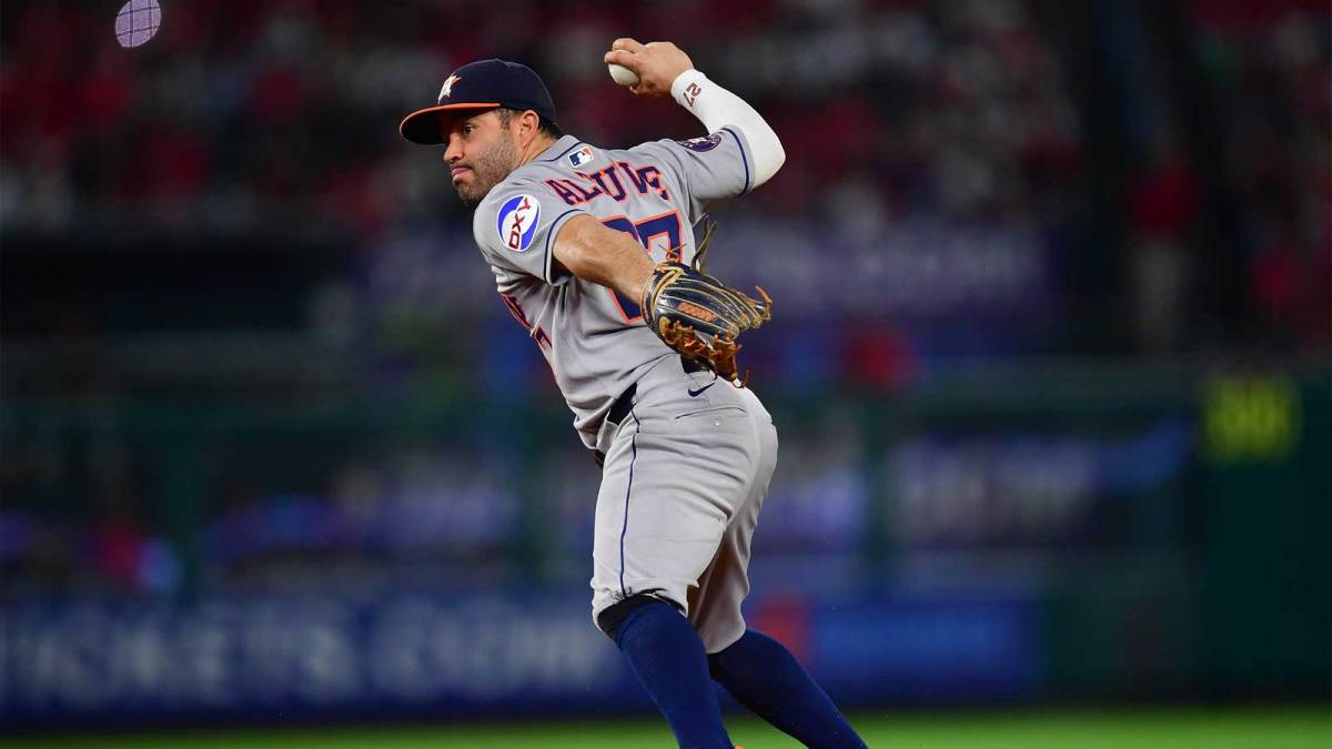 Houston Astros second baseman Jose Altuve (27) throws to first for the out against Los Angeles Angels right fielder Jo Adell (7) during the sixth inning at Angel Stadium.