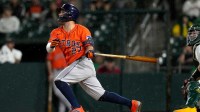 Houston Astros second baseman Jose Altuve (27) hits a fly ball against the Athletics in the sixth inning at Sutter Health Park.