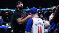 New York Knicks guard Jose Alvarado (15) signs autographs before the start of the game against the Boston Celtics at TD Garden.