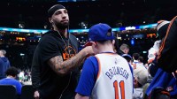 New York Knicks guard Jose Alvarado (15) signs autographs before the start of the game against the Boston Celtics at TD Garden.