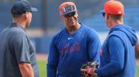 New York Mets outfielder Juan Soto (22) speaks to managers Carlos Mendoza (right) and assistant general manager Eduardo Brizuela (left) during spring training at Clover Park.