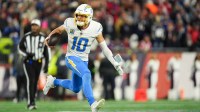 Los Angeles Chargers quarterback Justin Herbert (10) scrambles during the fourth quarter against the New England Patriots in an AFC Wild Card Round game at Gillette Stadium