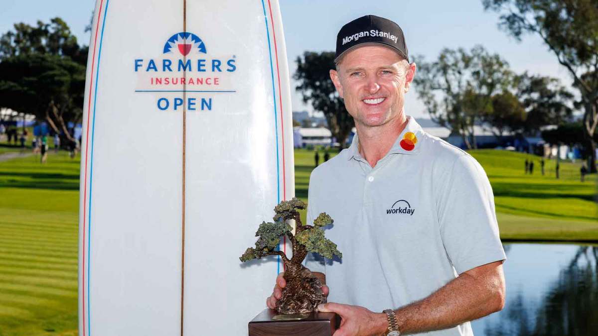 Justin Rose holds the Farmers Insurance trophy after winning the Farmers Insurance Open golf tournament at Torrey Pines Municipal Golf Course - South Course.