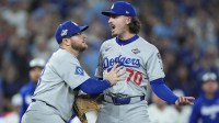 Los Angeles Dodgers third baseman Max Muncy (13) and pitcher Justin Wrobleski (70) react after Toronto Blue Jays shortstop Andres Gimenez (0) is hit by a pitch in the fourth inning during game seven of the 2025 MLB World Series at Rogers Centre.