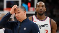 Los Angeles Clippers head coach Tyronn Lue scratches his head after calling a time out as forward Kawhi Leonard (2) walks past in the first half against the Toronto Raptors at Scotiabank Arena.