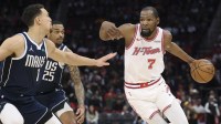 Houston Rockets forward Kevin Durant (7) dribbles the ball as Dallas Mavericks forward Dwight Powell (7) defends during the first quarter at Toyota Center.