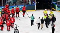 Kevin Fiala of Switzerland is taken off the ice by medical staff on a stretcher after sustaining an injury against Canada in men's ice hockey group A play during the Milano Cortina 2026 Olympic Winter Games at Milano Santagiulia Ice Hockey Arena.