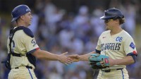 Los Angeles Dodgers first baseman Kiki Hernandez (8) shakes hands with Los Angeles Dodgers catcher Will Smith (16) after pitching a scoreless the ninth inning against the New York Yankees at Dodger Stadium.