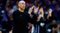 Kings head coach Doug Christie cheers on during the fourth quarter against the Washington Wizards at Golden 1 Center with Kings GM Scott Perry in the background
