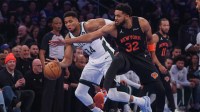 Bucks forward Giannis Antetokounmpo (34) and New York Knicks center Karl-Anthony Towns (32) battle for the ball during the first half at Madison Square Garden