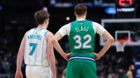 Charlotte Hornets guard Kon Knueppel (7) stands with Dallas Mavericks forward Cooper Flagg (32) during the second half at American Airlines Center.