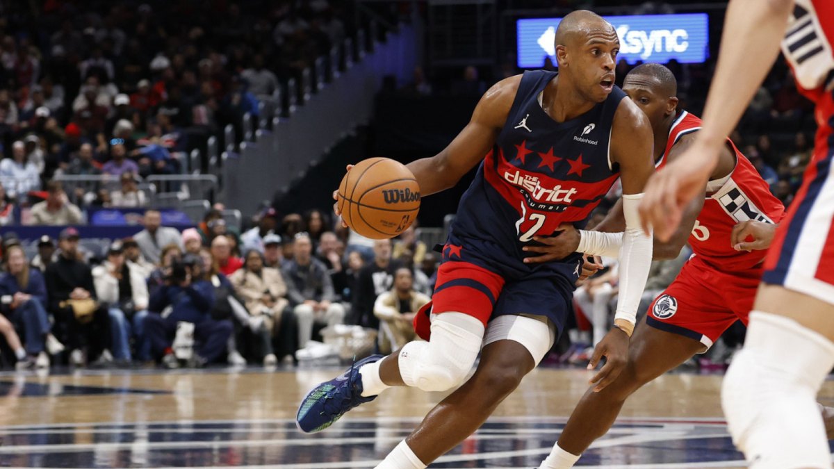 Jan 19, 2026; Washington, District of Columbia, USA; Washington Wizards forward Khris Middleton (22) drives to the basket as LA Clippers guard Kris Dunn (8) defends in the first half at Capital One Arena.