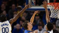 Orlando Magic forward Franz Wagner (22) shoots between Golden State Warriors forwards Jonathan Kuminga (00) and Trayce Jackson-Davis (32) during the third quarter at Chase Center.