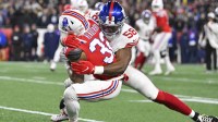 New York Giants linebacker Bobby Okereke (58) tackles New England Patriots running back TreVeyon Henderson (32) during the first quarter at Gillette Stadium.