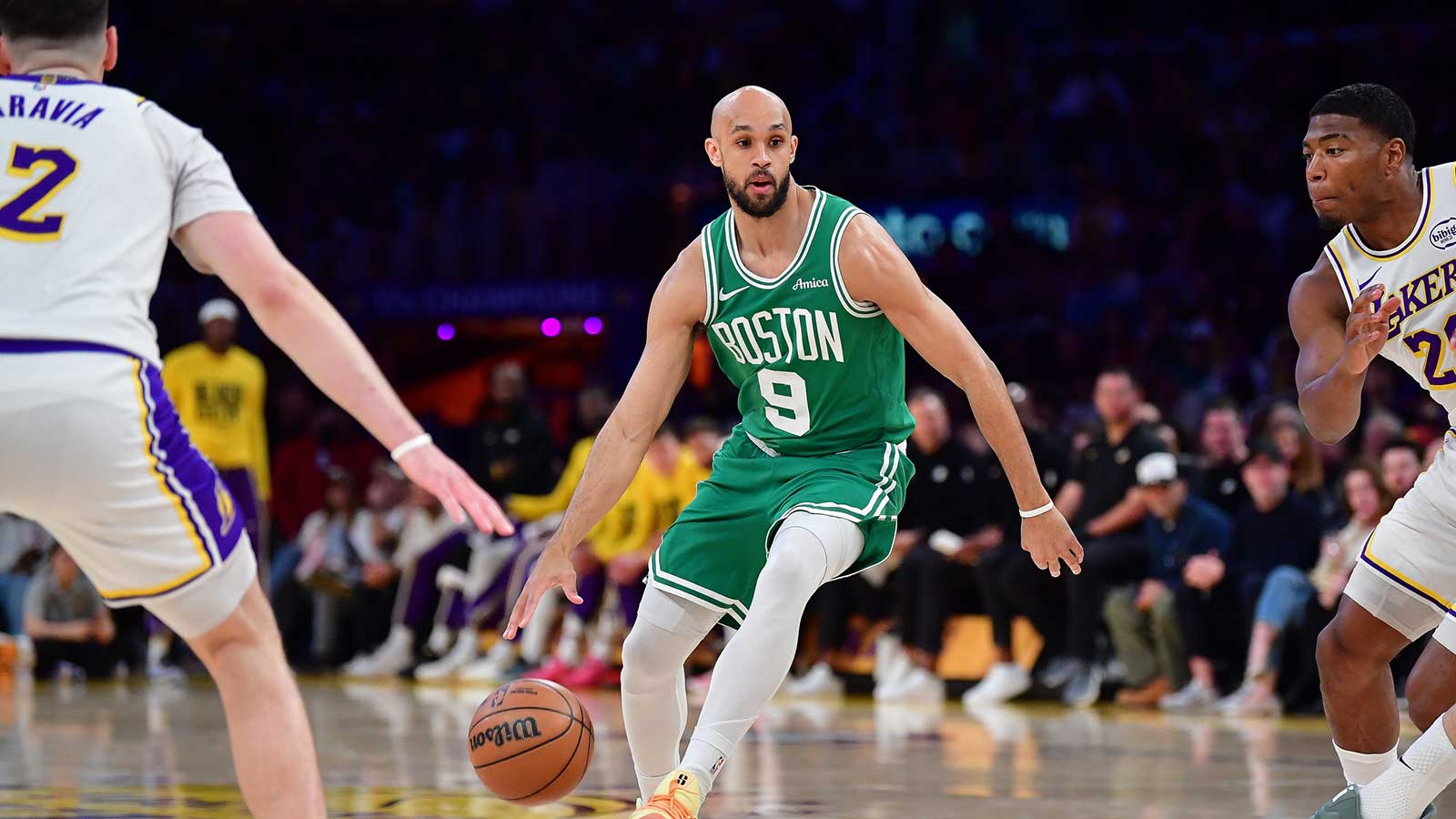 Celtics guard Derrick White (9) moves the ball against Los Angeles Lakers forward Jake LaRavia (12) and forward Rui Hachimura (28) during the first half at Crypto.com Arena