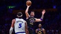 Lakers guard Luka Doncic (77) shoots against