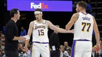 Los Angeles Lakers head coach JJ Redick talks with guard Austin Reaves (15) and guard Luka Doncic (77) during the fourth quarter against the Memphis Grizzlies at FedExForum.