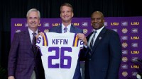 LSU president Wade Rousse, left, LSU new head coach Lane Kiffin and LSU athletic director Verge Ausberry stand together at South Stadium Club at Tiger Stadium.
