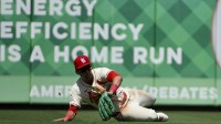 St. Louis Cardinals left fielder Lars Nootbaar (21) slides and catches line drive hit by Cincinnati Reds left fielder Connor Joe (not pictured) during the eighth inning at Busch Stadium.