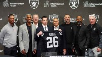Las Vegas Raiders coach Klint Kubiak (center) poses at introductory press conference at Intermountain Health Performance Center. From left: Marcus Allen, Mike Haynes, Howie Long, Kubiak, general manager John Spyktek, Charles Woodson and Rich Gannon. Mandatory Credit: Kirby Lee-Imagn Images