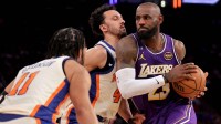 Los Angeles Lakers forward LeBron James (23) drives to the basket against New York Knicks guards Jalen Brunson (11) and Landry Shamet (44) during the third quarter at Madison Square Garden.