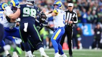 Los Angeles Rams quarterback Matthew Stafford (9) passes against Seattle Seahawks defensive end DeMarcus Lawrence (0) during the first half in the 2026 NFC Championship Game at Lumen Field.